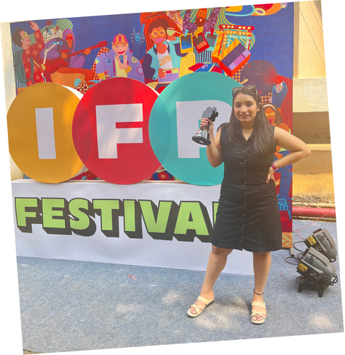 Nikita Arya holding the Gold Think Piece trophy at India Film Project Season 13